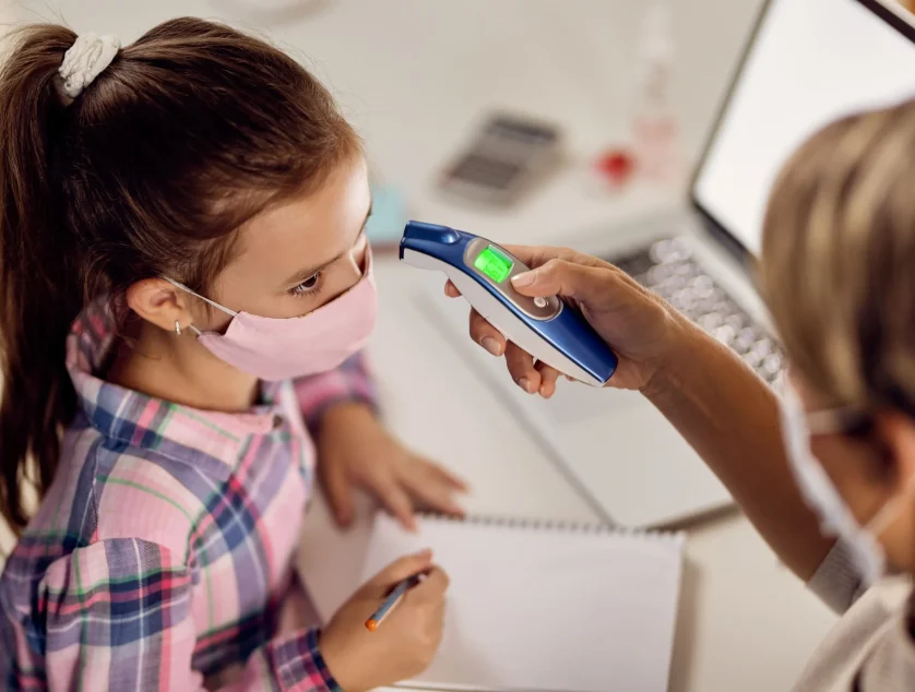 small-girl-getting-her-temperature-measured-with-infrared-thermometer